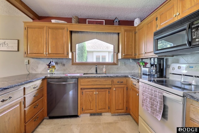 kitchen with black microwave, stainless steel dishwasher, white range with electric stovetop, visible vents, and dark stone counters