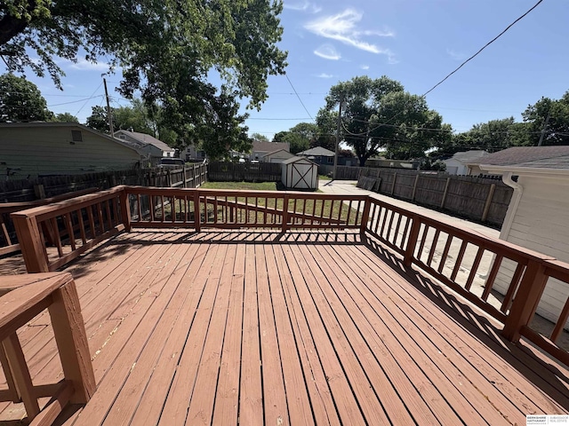 1626 N C St, Fremont, NE 68025 - wooden deck with a fenced backyard, a shed, and an outdoor structure