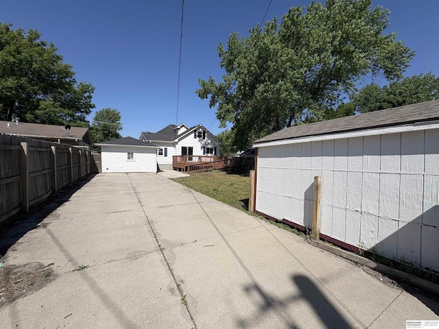 1626 N C St, Fremont, NE 68025 - view of side of home with fence, a deck, and an outbuilding