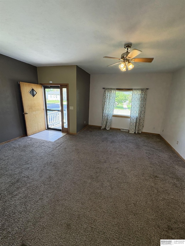 1626 N C St, Fremont, NE 68025 - unfurnished room featuring healthy amount of natural light, a ceiling fan, and baseboards