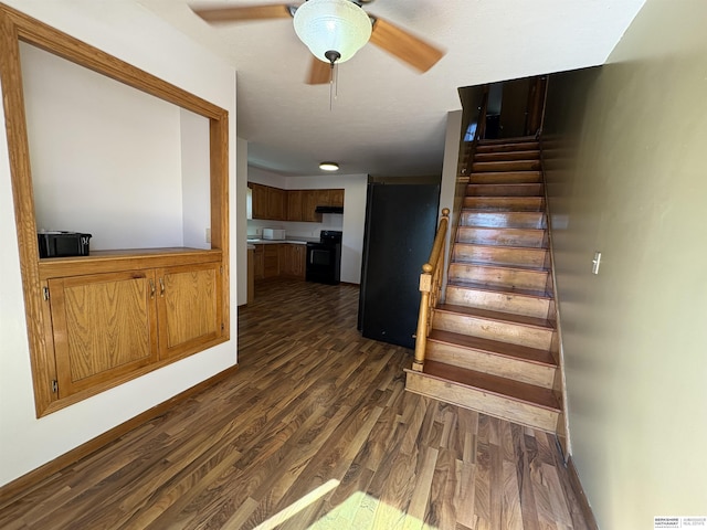 1626 N C St, Fremont, NE 68025 - stairway with wood finished floors, ceiling fan, and baseboards