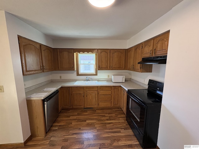 1626 N C St, Fremont, NE 68025 - kitchen with black electric range, under cabinet range hood, a sink, dishwasher, and dark wood-style flooring