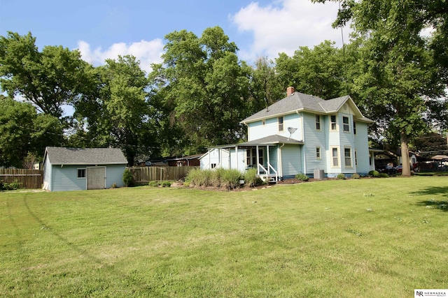 view of yard with an outbuilding and fence