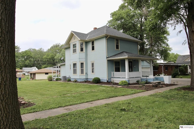 view of front of property featuring covered porch, a shingled roof, cooling unit, and a front lawn