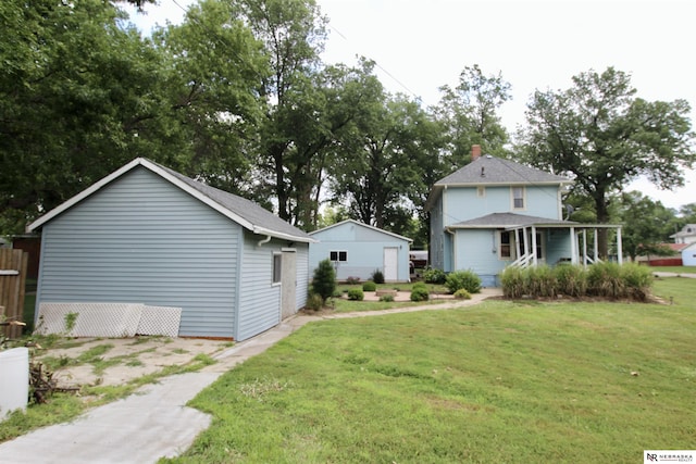 rear view of house featuring a yard