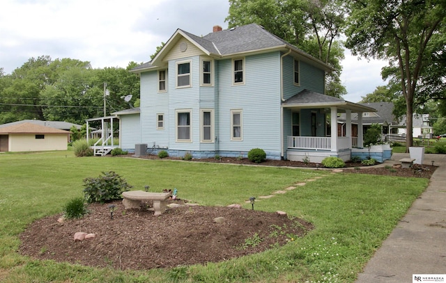 view of front of home with cooling unit, a front lawn, a porch, a shingled roof, and a chimney
