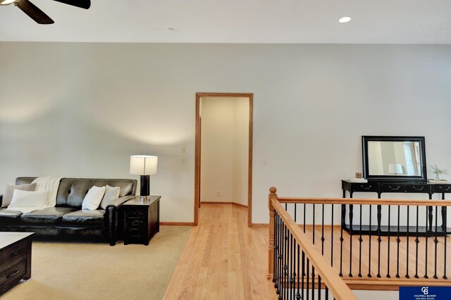 living room featuring a ceiling fan, baseboards, light wood-style flooring, and recessed lighting
