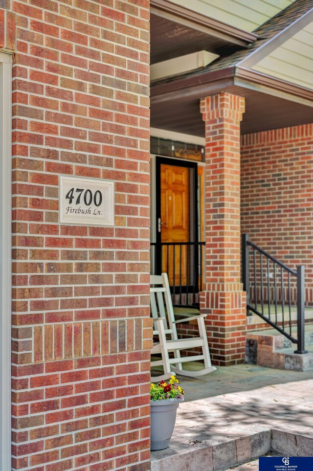 property entrance featuring brick siding