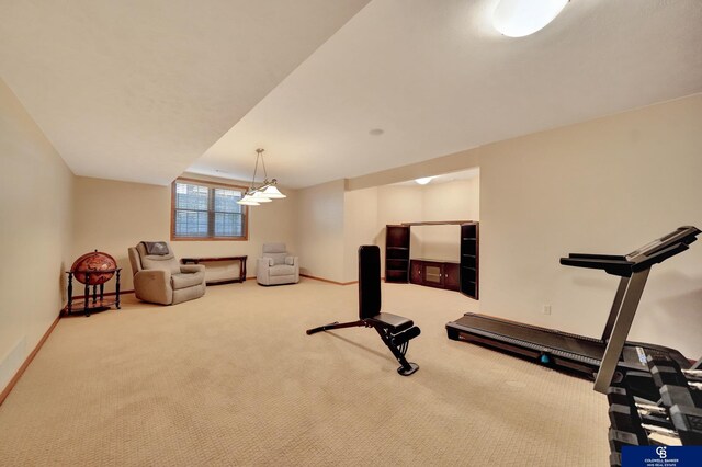 workout area with baseboards and carpet