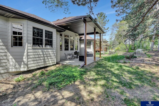 back of property with a patio area and a lawn