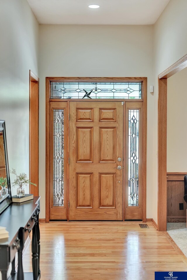 entrance foyer with light wood-style floors and baseboards