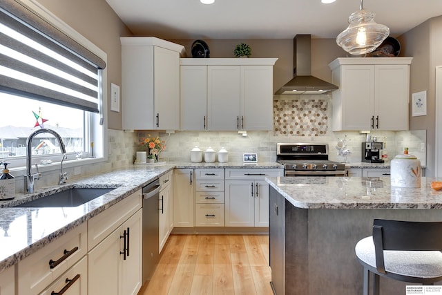 8914 N 171st St, Bennington, NE 68007 - kitchen with wall chimney range hood, appliances with stainless steel finishes, a sink, light wood-style flooring, and tasteful backsplash