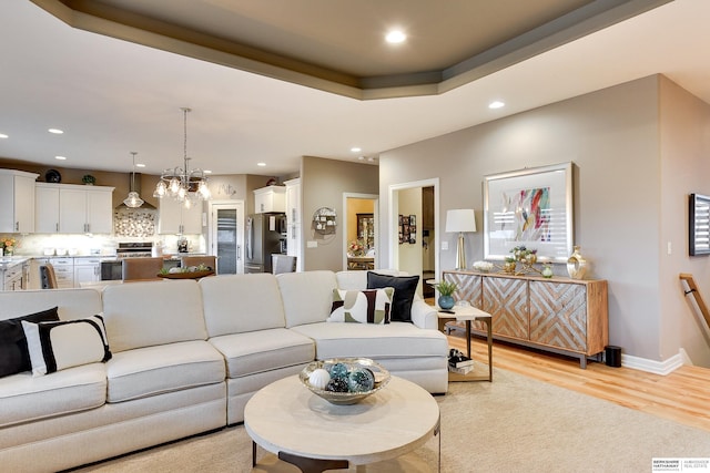 8914 N 171st St, Bennington, NE 68007 - living room with recessed lighting, light wood-style floors, a chandelier, and baseboards