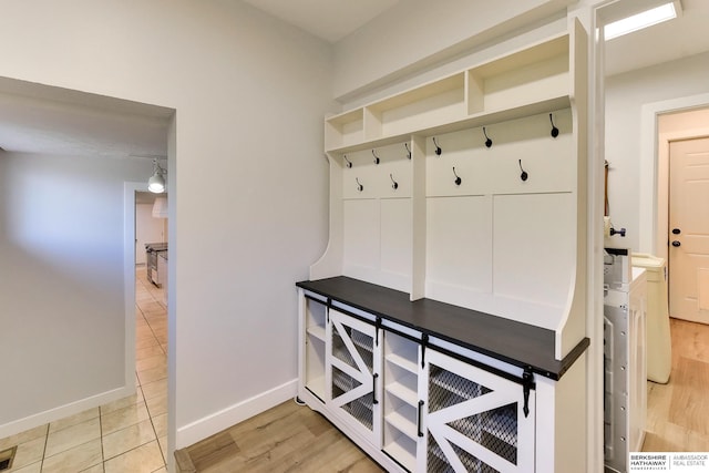 mudroom featuring baseboards and light wood-type flooring