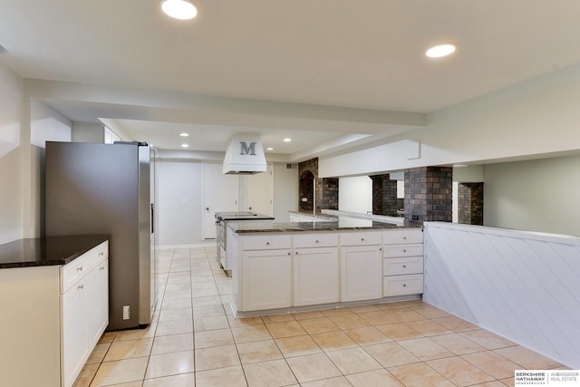 kitchen featuring light tile patterned floors, white cabinets, and stainless steel appliances
