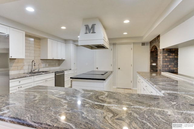 kitchen with decorative backsplash, a kitchen island, stainless steel dishwasher, a sink, and black electric stovetop