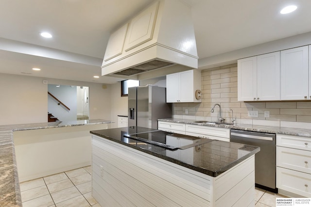 kitchen featuring decorative backsplash, custom exhaust hood, recessed lighting, a sink, and appliances with stainless steel finishes