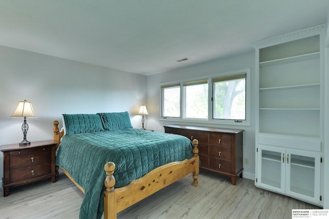 bedroom featuring visible vents and light wood-style flooring
