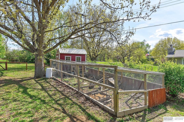 view of yard featuring exterior structure and an outbuilding