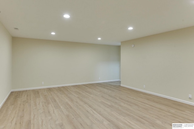 unfurnished room with recessed lighting, light wood-style floors, visible vents, and baseboards