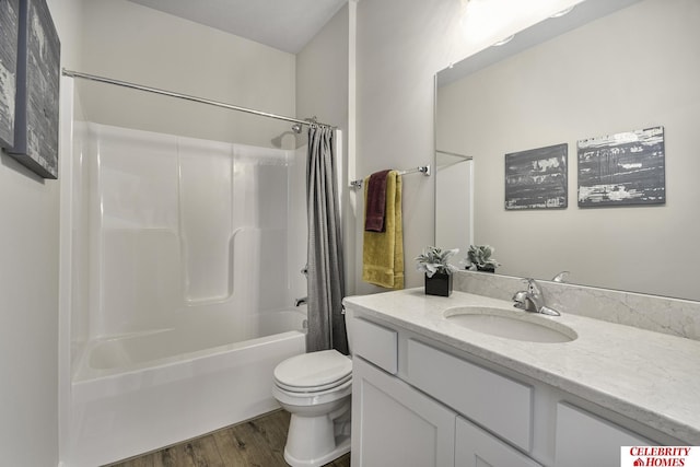 bathroom with shower / bathtub combination with curtain, toilet, vanity, and wood finished floors