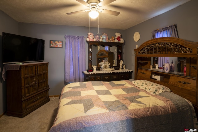 carpeted bedroom with a ceiling fan and a textured ceiling