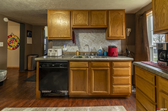 kitchen with a textured ceiling, decorative backsplash, dark wood finished floors, a sink, and black dishwasher