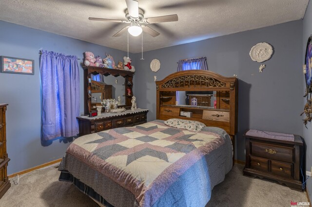 carpeted bedroom with baseboards, a ceiling fan, and a textured ceiling