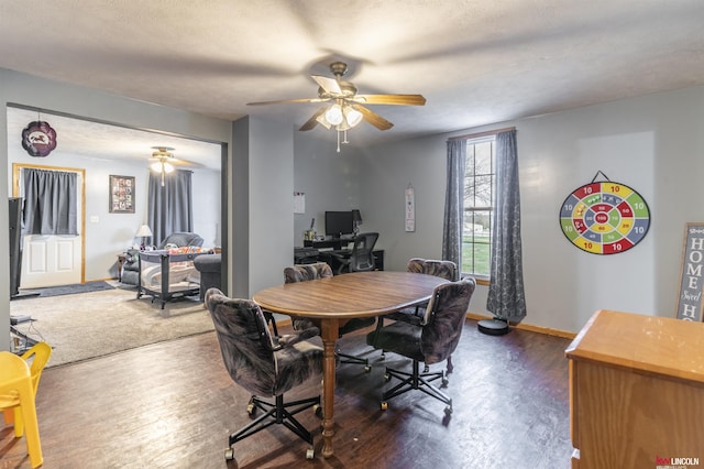 dining area with baseboards, ceiling fan, and dark wood finished floors