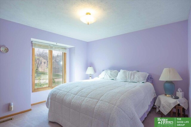 carpeted bedroom with baseboards and visible vents
