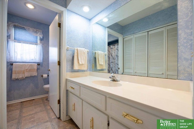 full bathroom featuring vanity, baseboards, a closet, toilet, and visible vents