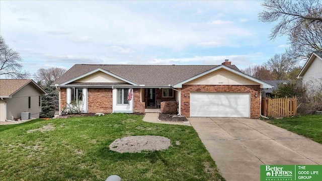 single story home with concrete driveway, a front lawn, an attached garage, brick siding, and fence