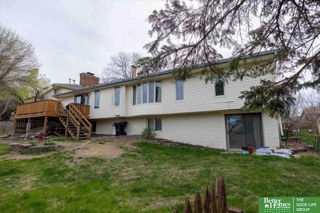 rear view of house featuring a wooden deck, a lawn, stairway, fence, and a chimney