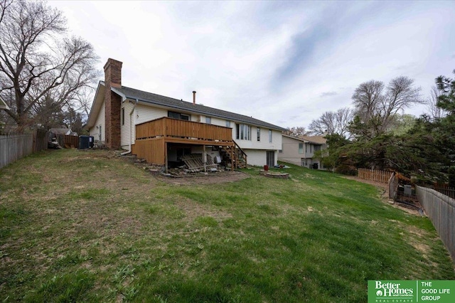 back of property with central AC, a yard, a fenced backyard, stairway, and a deck