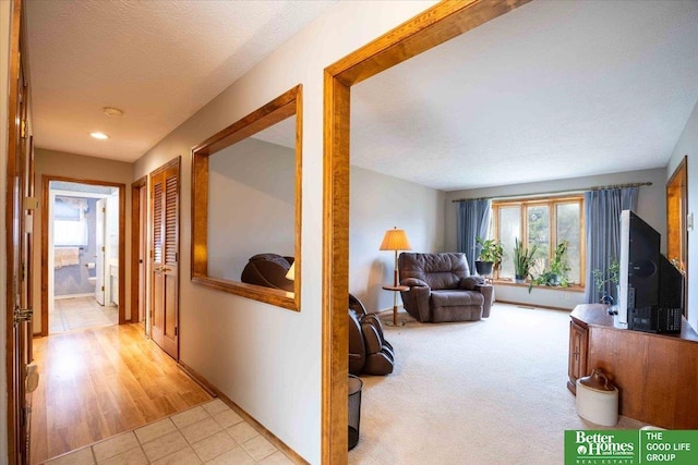 hall with light tile patterned floors and baseboards
