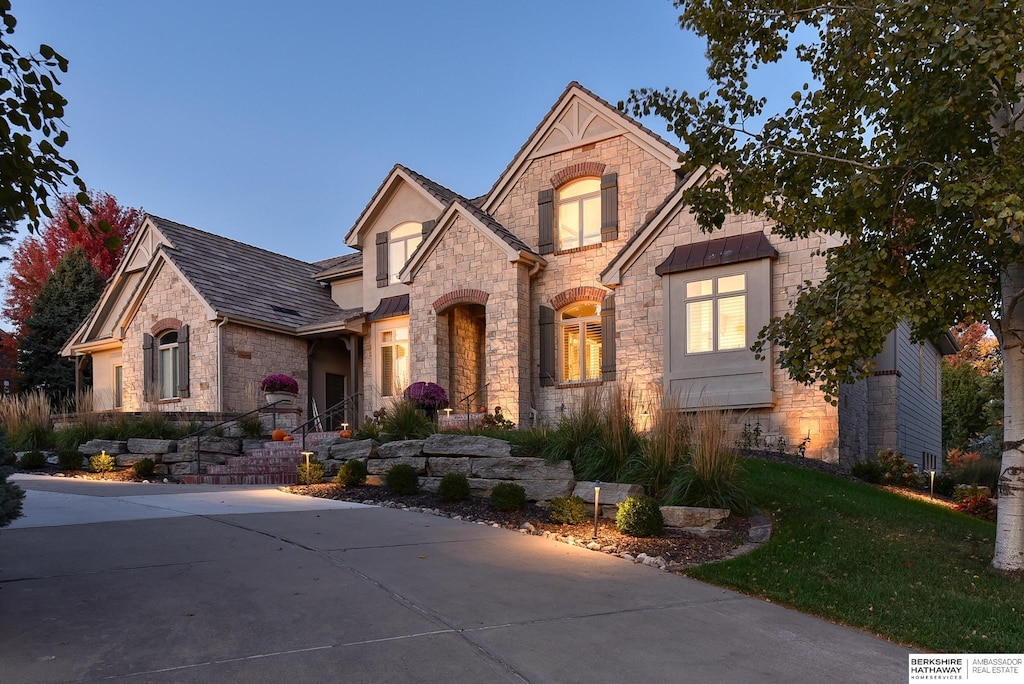 13650 Hamilton St, Omaha, NE 68154 - french country style house featuring stone siding and a front yard