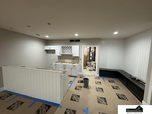 living area featuring visible vents and recessed lighting