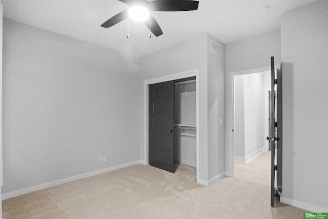 unfurnished bedroom featuring a closet, baseboards, visible vents, ceiling fan, and carpet