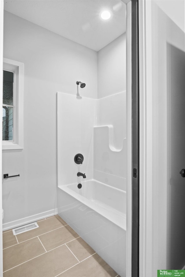 full bath featuring shower / bath combination, baseboards, visible vents, and tile patterned floors
