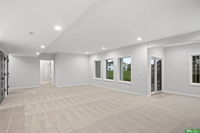 interior space with light carpet, baseboards, visible vents, and recessed lighting