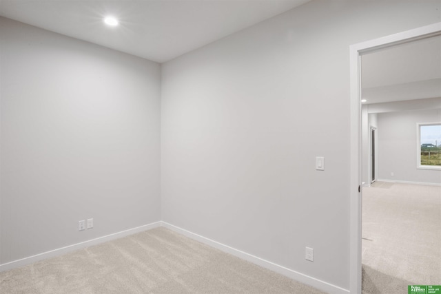 unfurnished room featuring baseboards, recessed lighting, and light colored carpet