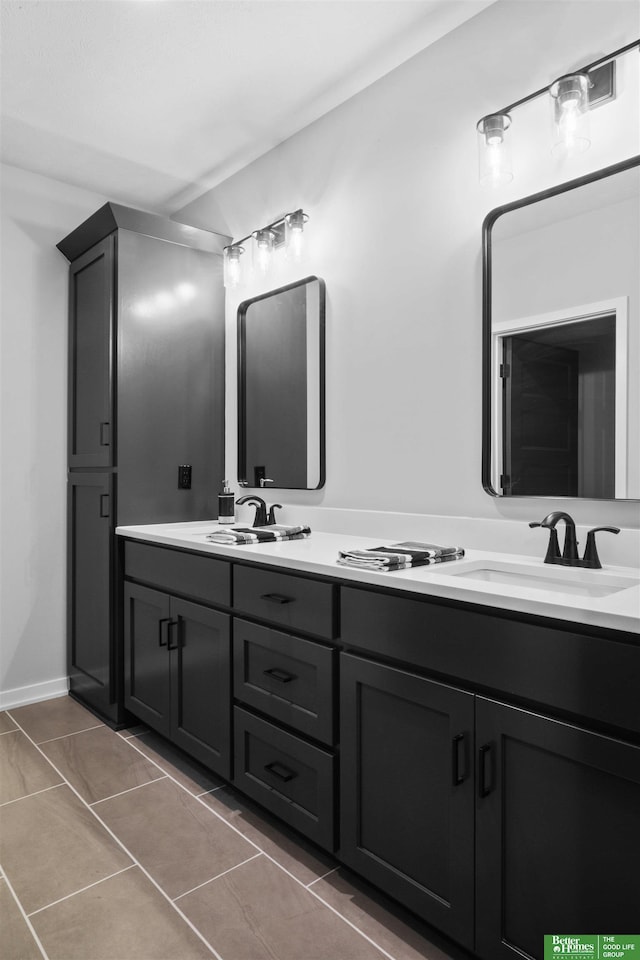 bathroom featuring tile patterned floors, double vanity, and a sink