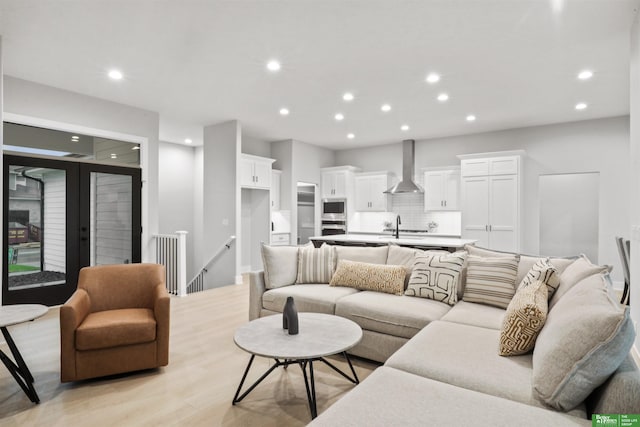 living area with light wood-style flooring and recessed lighting