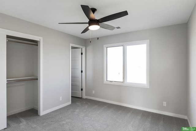 unfurnished bedroom featuring a closet, carpet, baseboards, and ceiling fan