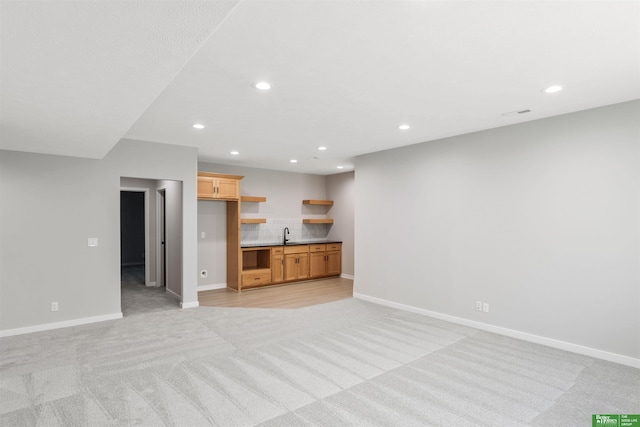 unfurnished living room with light colored carpet, baseboards, and recessed lighting