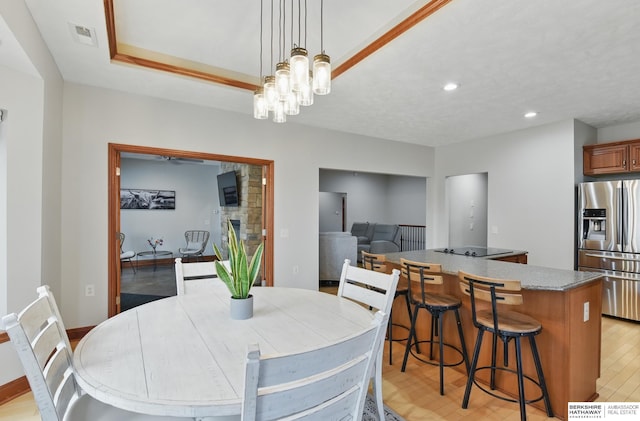 8153 Swallowtail St, Papillion, NE 68046 - dining space with recessed lighting, a stone fireplace, light wood-style floors, and baseboards