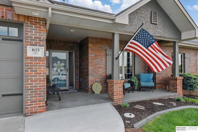 8153 Swallowtail St, Papillion, NE 68046 - property entrance featuring brick siding and a porch