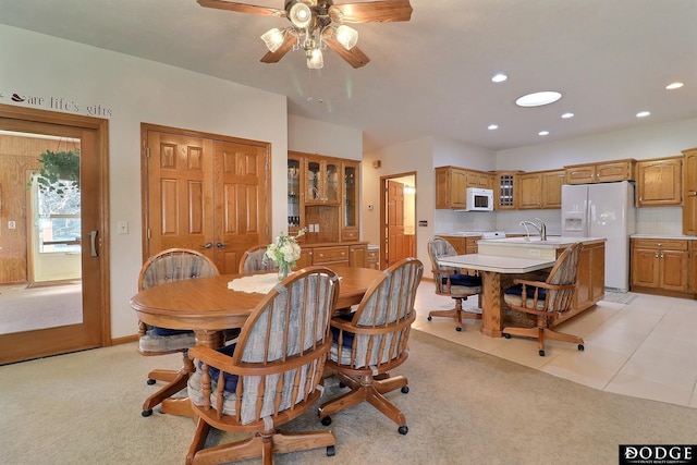 dining room featuring light carpet, recessed lighting, a ceiling fan, and light tile patterned flooring