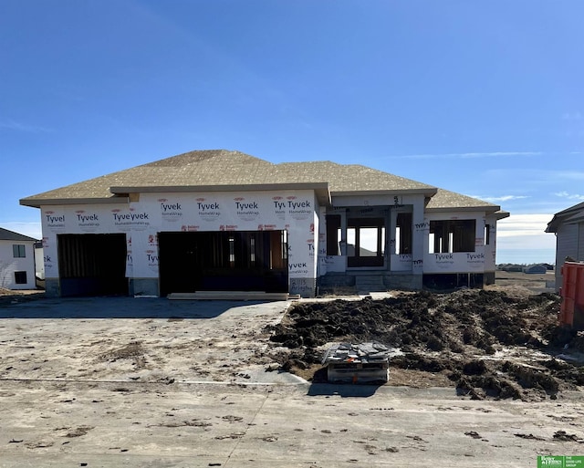 property in mid-construction with a garage and concrete driveway