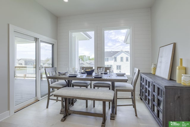 dining area featuring wood walls